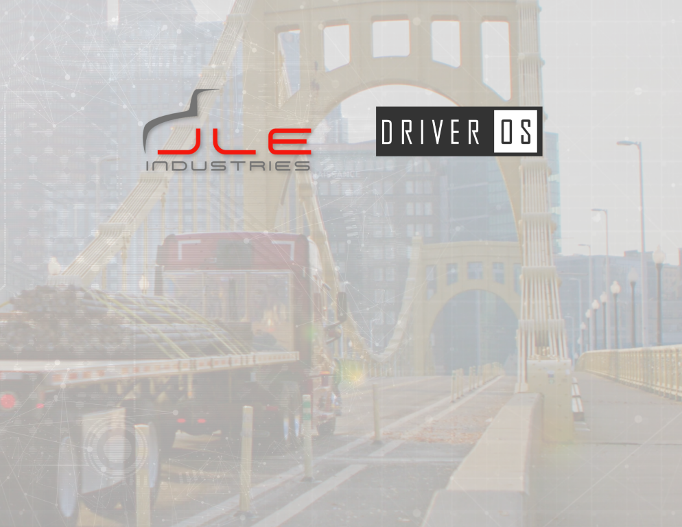 Flatbed truck driving over bridge with JLE and DriverOS logos above
